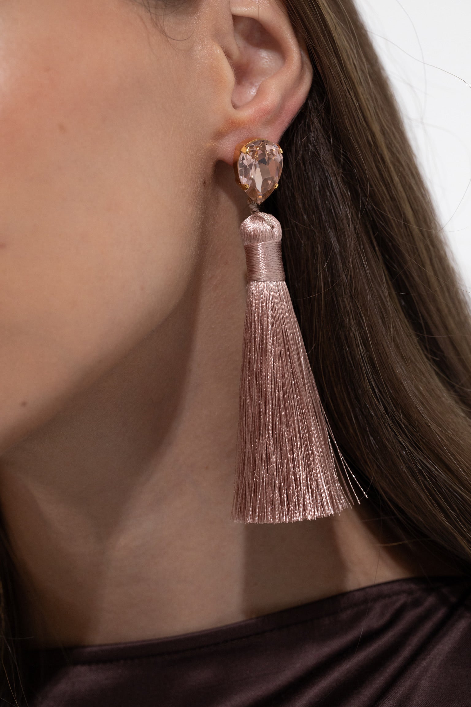 Jennifer Behr Francine Earrings, Close-up of a woman wearing a rose gold tassel earring with a pink gemstone, Charlotte, NC