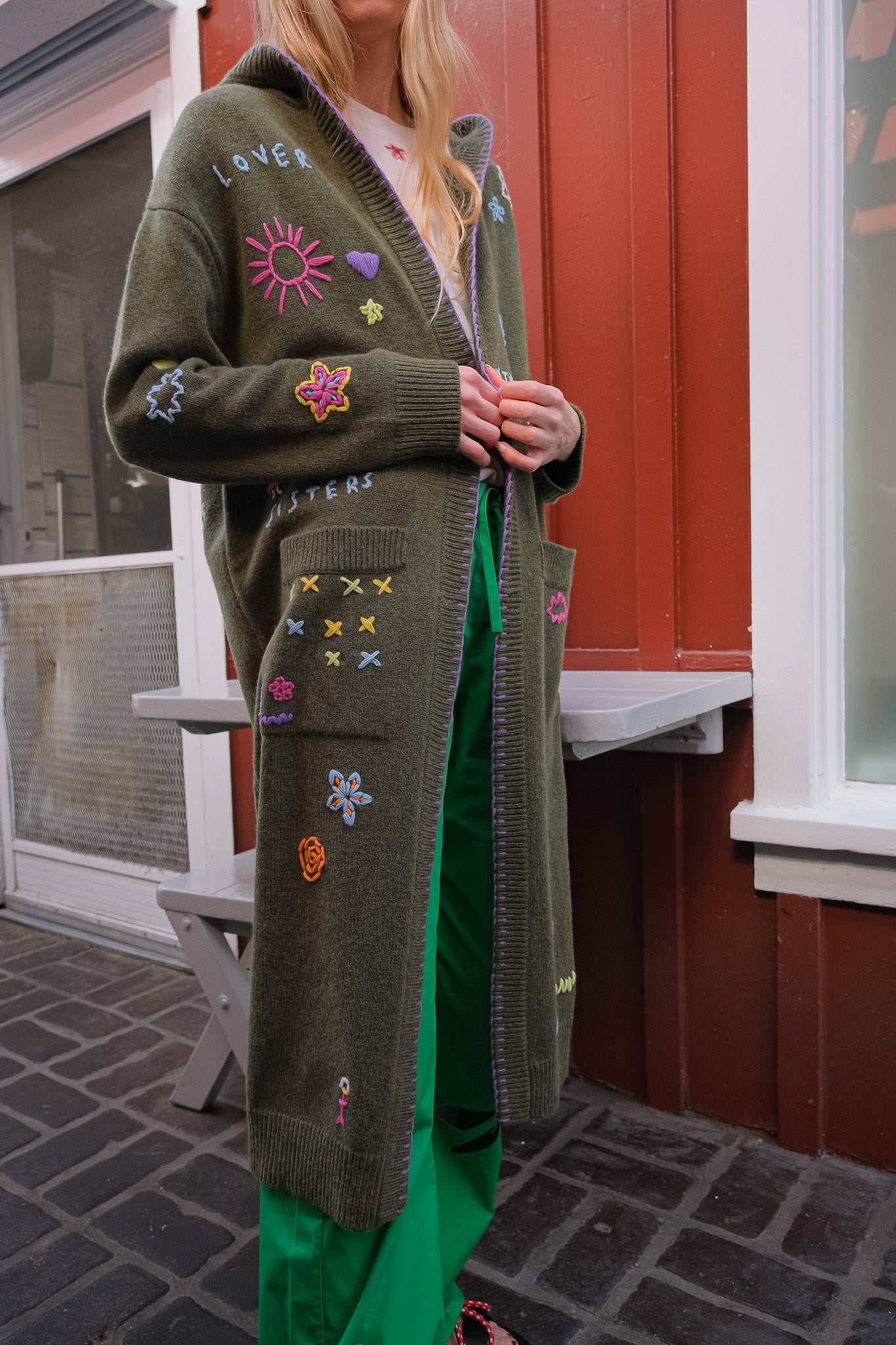 MIRA MIKATI | LONG DOODLE CARDIGAN | Long knit cardigan | Open front | Hooded | Front patch pockets | Multi-colored doodle embroidery throughout | Composition: 55% RWS wool, 25% recycled polyamide, 20% organic cotton |
Care: Gentle hand wash or dry clean | Made in China | Charlotte, NC